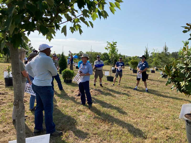 Speaker, Mark Russell, sharing information regarding a number of Florida native trees at Enviro Pro Tree Farm.